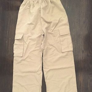 Tan, loose around the ankles and waist. Pants that can be styled with anything